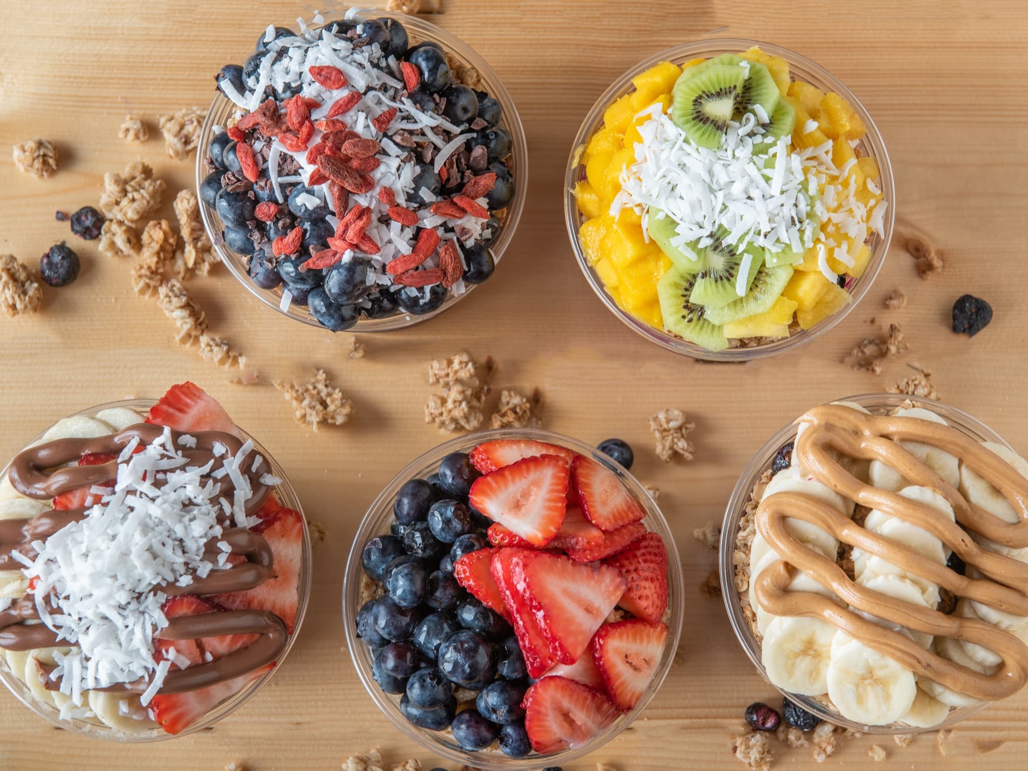 Bonita Bowls açaí bowls from above, topped with fresh fruit, granola, coconut, and peanut butter