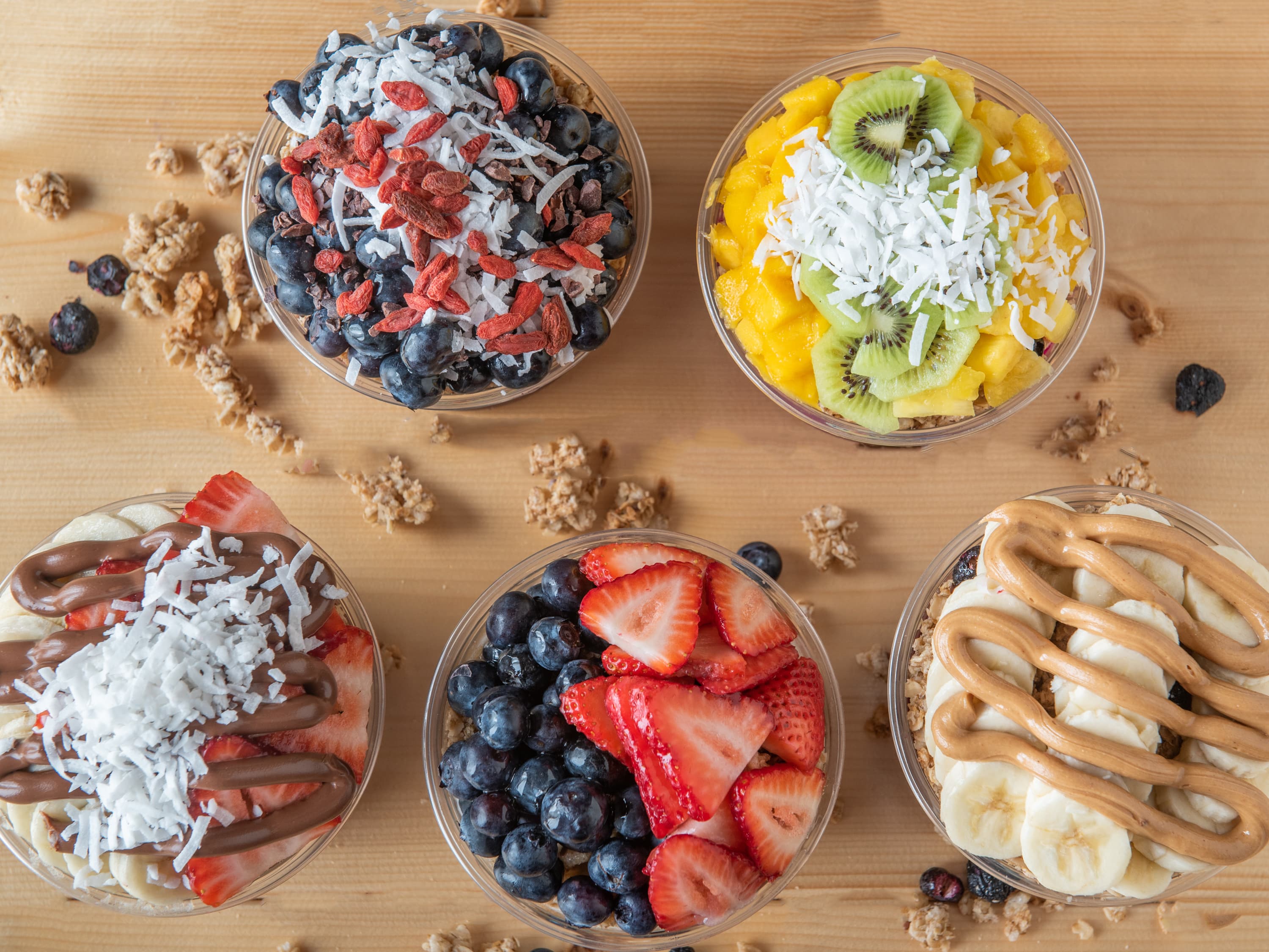 A flatlay spread of Bonita Bowls açaí bowls and toppings, set up for an event